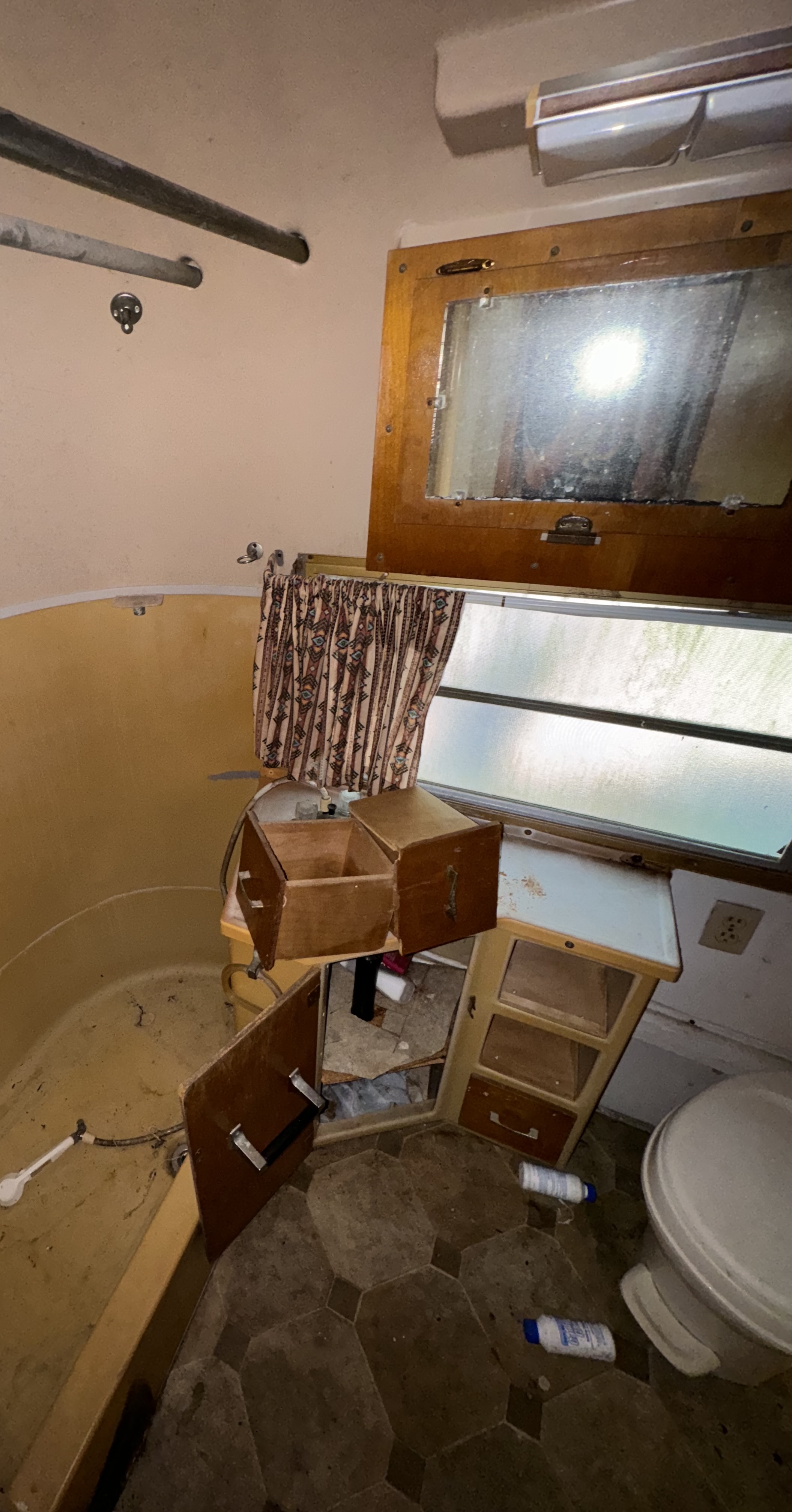 Camper bathroom before: older finishes and fixtures