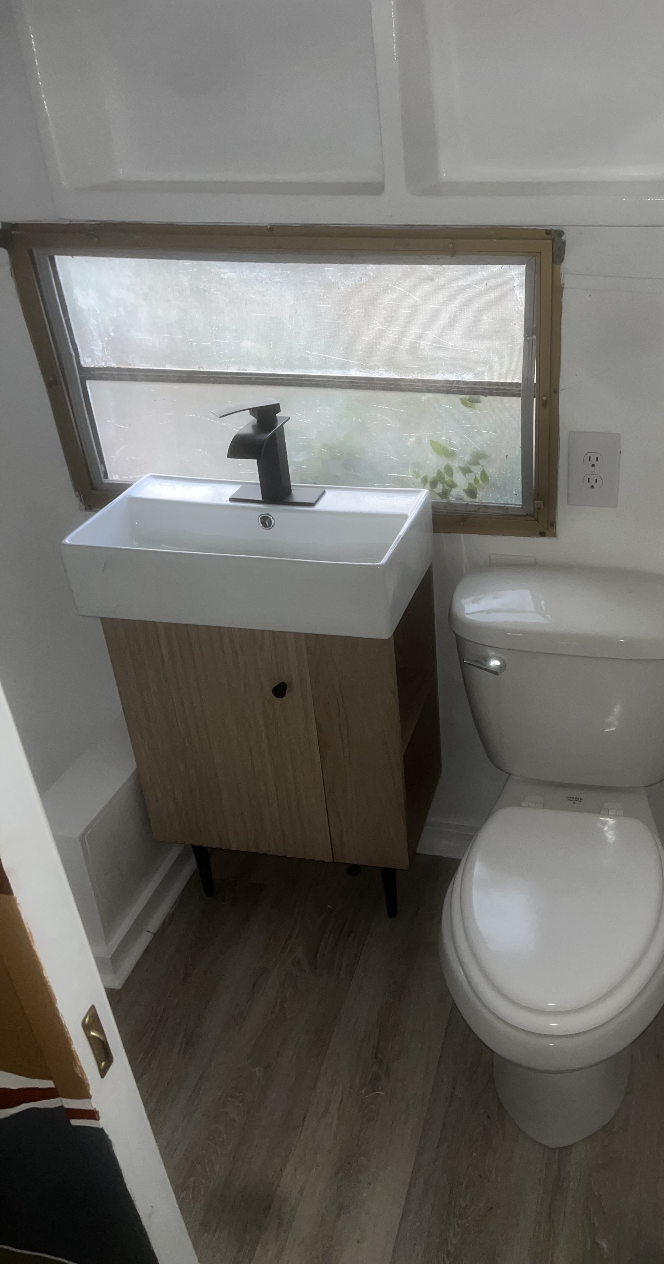 Camper bathroom after: modern vanity and updated fixtures