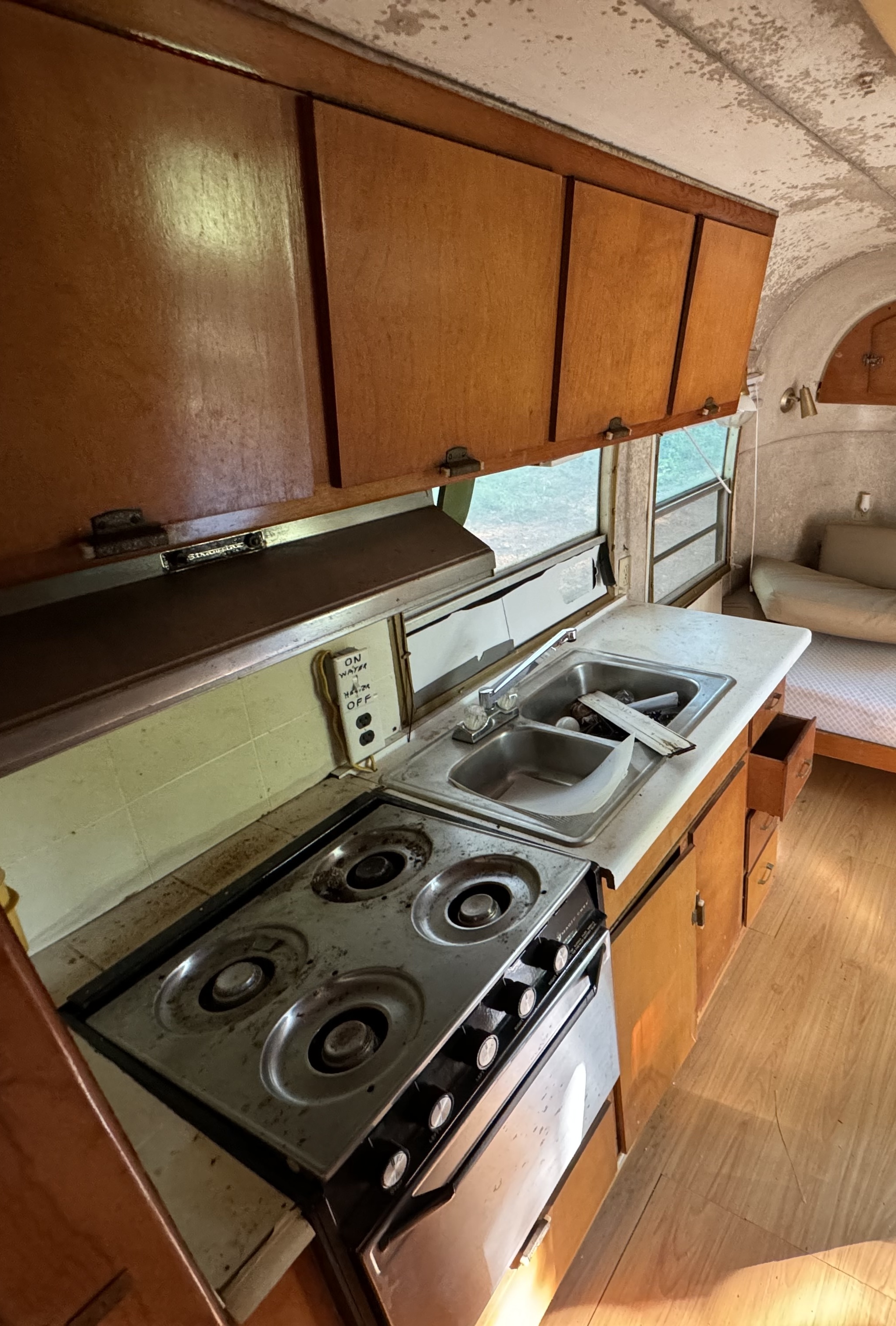 Vintage camper kitchen before: dated fixtures and surfaces