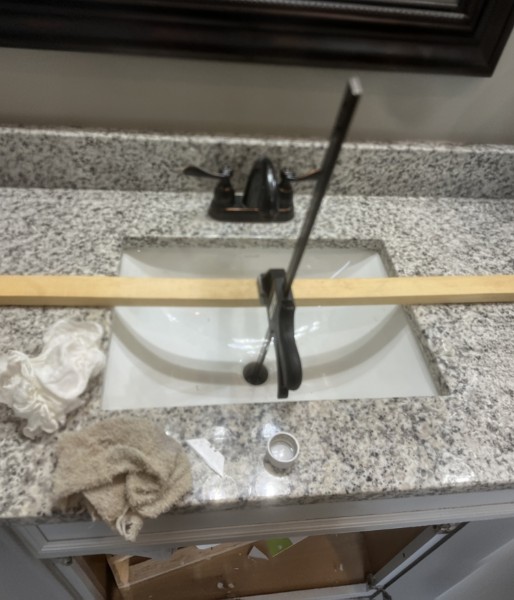 Bathroom vanity before: old basin and setup